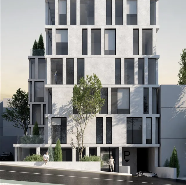 Facade detail of a residential building with trees and balconies